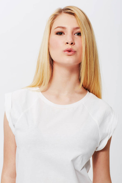 Natural, young and absolutely gorgeous. A pretty young blonde isolated on a white background - 写真・画像