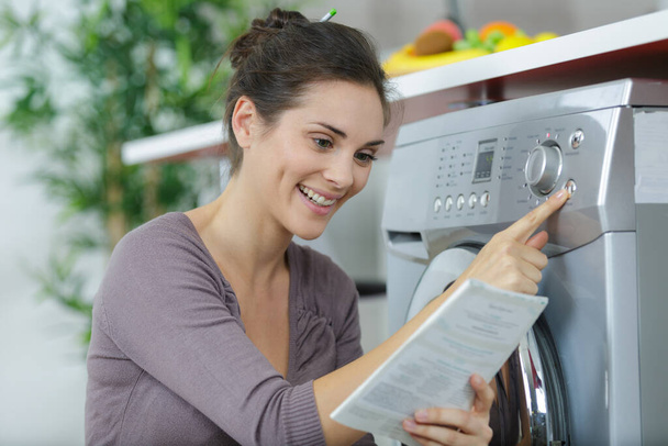 woman using new washing machine - Foto, imagen