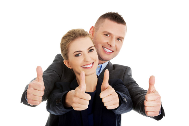 Business couple showing thumbs up - Foto, afbeelding