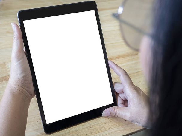 Mockup of a woman holds tablet computer with isolated screen in her hands. View from above. Clipping path - Fotó, kép