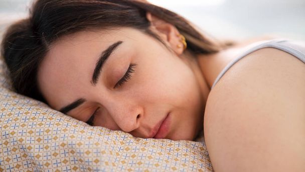  Young beautiful woman sleeping on the bed - Photo, Image
