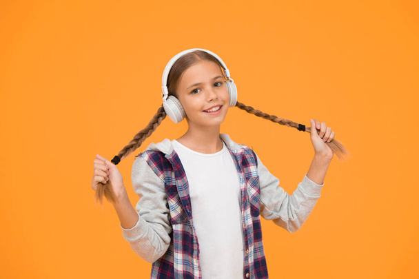 Headphones with wireless technology. Small child listening to music modern wireless earphones. Happy little girl wearing modern headphones. Cute kid enjoying stereo sound. Wireless means freedom. - Fotoğraf, Görsel