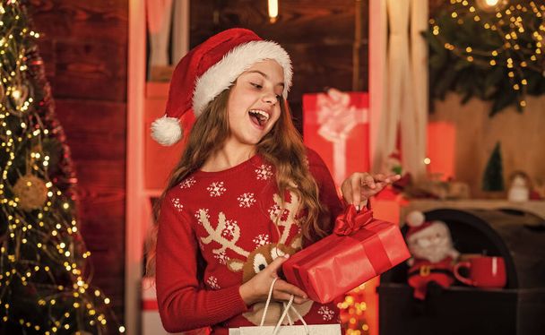 black friday. new year sale concept. kid in winter clothes shopping for Christmas holiday. Kid holding xmas shopping bag gift. Big discount. Purchasing of goods and gifts. shopping for family. - 写真・画像