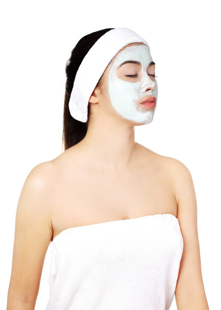 Relaxed woman with a nourishing face mask - Fotoğraf, Görsel