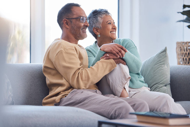 Elderly couple, relax and smile watching tv, movie or streaming on sofa together at home. Senior man and woman relaxing on living room couch enjoying online shows, media or entertainment indoors. - Photo, Image