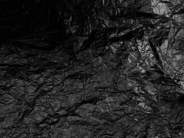 Crumpled black paper with texture. Dark black textured background. - Photo, Image