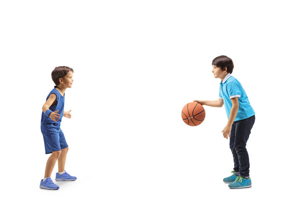 Full length profile shot of boys playing basketball isolated on white background - Foto, Imagem