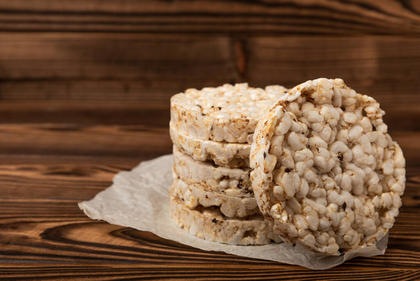 Rice cakes on an old brown tree. Diet bread. Useful food. Diet food. Gluten free. Space for copy. Space for text. - Photo, image