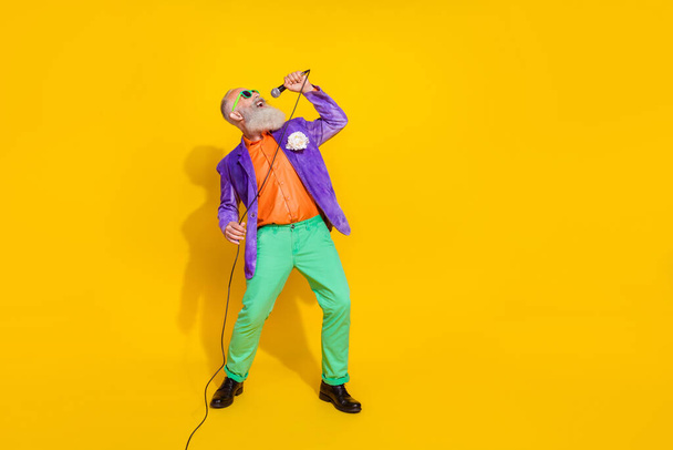 Full length photo of famous vocalist performer trendy costume sing event nice voice song empty space isolated on yellow color background. - Valokuva, kuva
