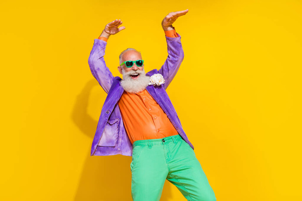 Photo portrait of attractive grandpa dance have fun celebrate retirement dressed stylish colorful look isolated on yellow color background. - Foto, Imagen