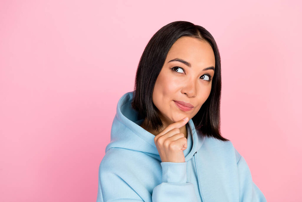 Photo of funny suspicious lady wear blue hoodie looking back empty space isolated pink color background. - Фото, зображення
