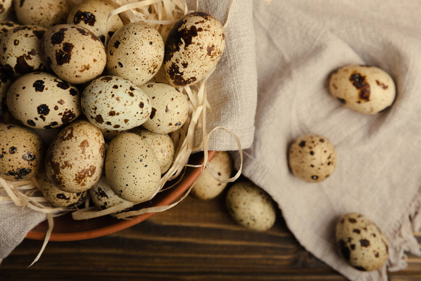 Quail eggs in a plate on a dark old brown wooden background. Eco product. Diet food. Healthy food. Space for text.Space for copy. - Φωτογραφία, εικόνα