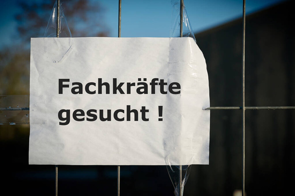  Notice on the fence of a company in Germany with the inscription Fachkrafte gesucht. Translation of the text: Professionals wanted                                 - Photo, Image