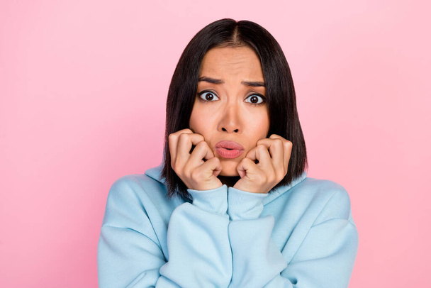 Photo portrait of lovely young lady concerned arms touch cheeks frightened worried wear trendy blue look isolated on pink color background. - Fotó, kép