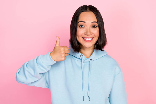 Photo of pretty confident girl dressed blue sweatshirt smiling showing thumb up isolated pink color background. - Fotoğraf, Görsel