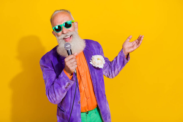 Photo of famous popular mc singer retired pensioner stylish bright costume celebrate event empty space isolated on yellow color background. - Valokuva, kuva