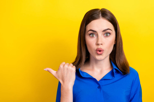 Photo of astonished pretty lady arm direct empty space impressed unexpected unbelievable discounts isolated on yellow color background. - Photo, Image