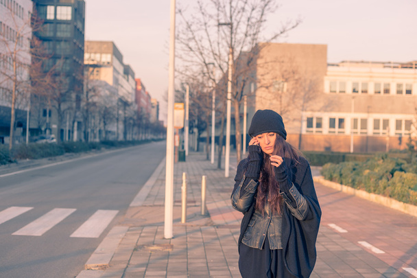 Beautiful young woman talking on phone in the city streets - 写真・画像