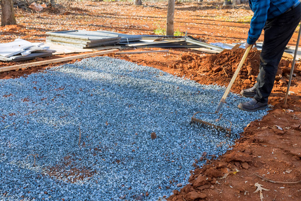 Creating level surface for gravel as deck foundation the shed in backyard. - Photo, Image