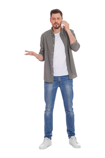 Man talking on phone against white background - Fotó, kép