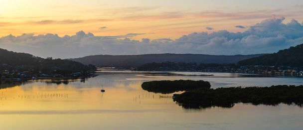 Aerial sunrise waterscape at the waterfront in Woy Woy on the Central Coast, NSW, Australia. - 写真・画像