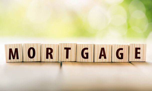 Wooden blocks arranged to form the word mortgage. planning savings a home concept for property, mortgage and real estate investment for a house. Buying a home on credit loan, Creating a family. - Fotoğraf, Görsel