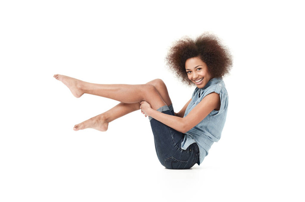 Check out my funky style. Smiling young african american woman in casual wear against a white background - Zdjęcie, obraz