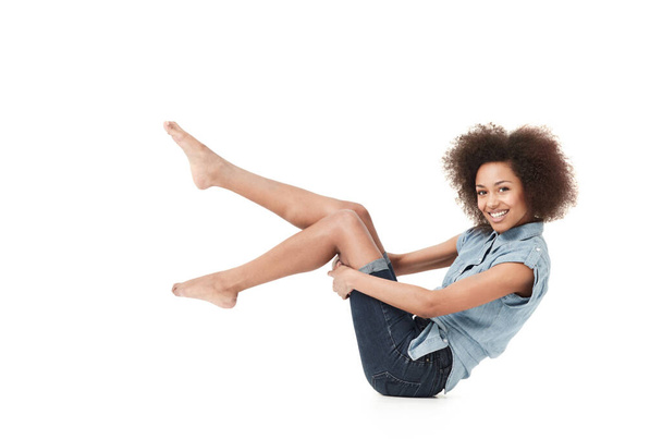 Feeling great in her casual style. Smiling young african american woman in casual wear against a white background - Photo, Image
