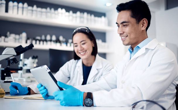 Research, collaboration and science with people and tablet in laboratory for medical, pharmacy and vaccine report. Teamwork, futuristic and analytics with man and woman for digital, review and test. - Valokuva, kuva