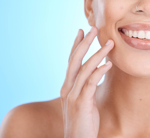 Beauty, face and skin, woman and skincare with hand for manicure, facial zoom and natural cosmetics, teeth and dental, cosmetic mockup. Healthy glow, wellness and teeth whitening with blue background. - Photo, Image