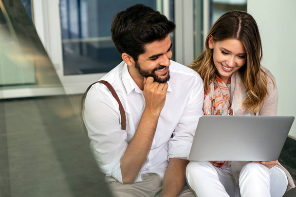 Happy business man and woman with digital devices outdoors. Business people happiness concept - Φωτογραφία, εικόνα