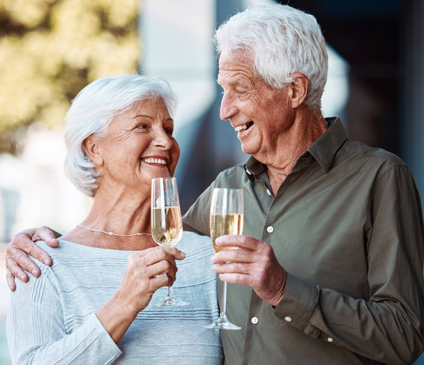 Senior couple, wine and toast outdoor, love or happiness celebration for anniversary or event together. Smile, happy or love with elderly man and woman with alcohol glass to celebrate and marriage. - Foto, immagini