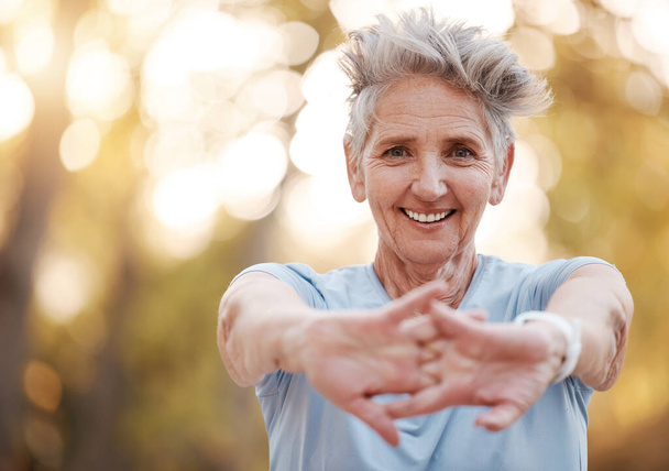 Happy, fitness or old woman stretching arms in nature for body wellness, training or outdoor exercise in Australia. Smile, portrait or elderly sports person exercising in warm up in forest in spring. - Φωτογραφία, εικόνα
