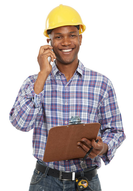 Technology - one step closer to your loved ones. Studio portrait of an african american man in construction clothing talking on a cellphone - Foto, imagen
