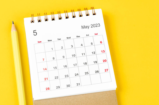 May 2023 Monthly desk calendar for 2023 with pencil on yellow background. - Photo, Image