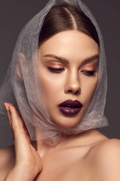 Modesty. Close-up portrait of glamorous female fashion model with artistic makeup expressing emotions over grey background. Style, beauty, high fashion, magazine style and ad - Foto, immagini