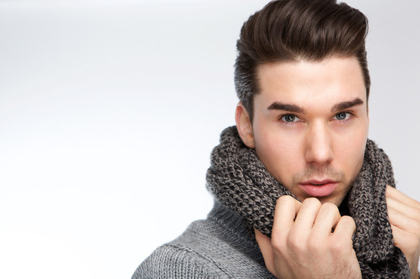 Trendy young man posing with gray wool scarf - Fotoğraf, Görsel