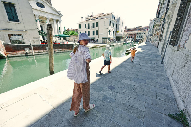 Kids walking near canal in Venice, Italy. - Photo, Image