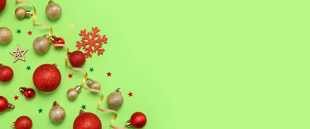 Beautiful composition with Christmas decorations on green background with space for text - Photo, Image