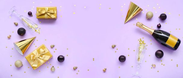 Party hats, Christmas gifts, balls, glasses and champagne on lilac background with space for text - Photo, Image