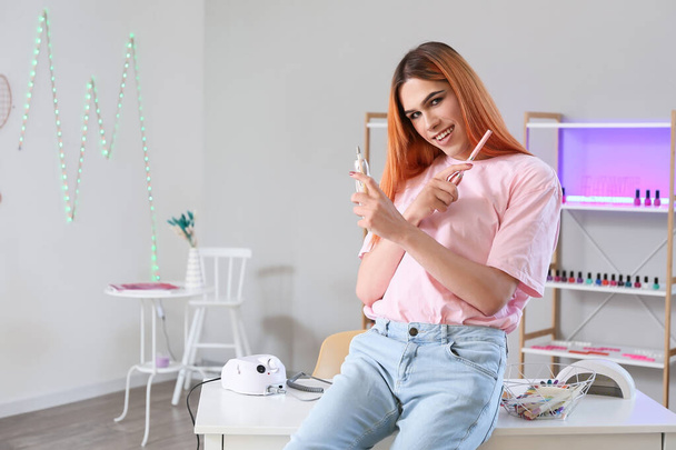 Transgender manicure master with tools in nail salon - Photo, Image
