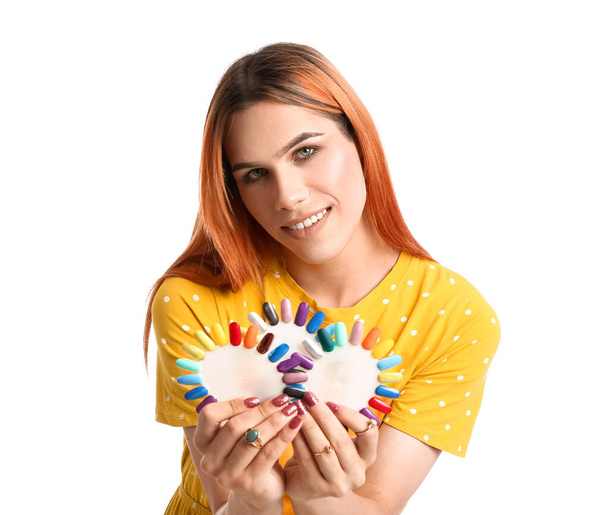 Mujer transgénero joven con puntas de esmalte de uñas sobre fondo blanco - Foto, Imagen
