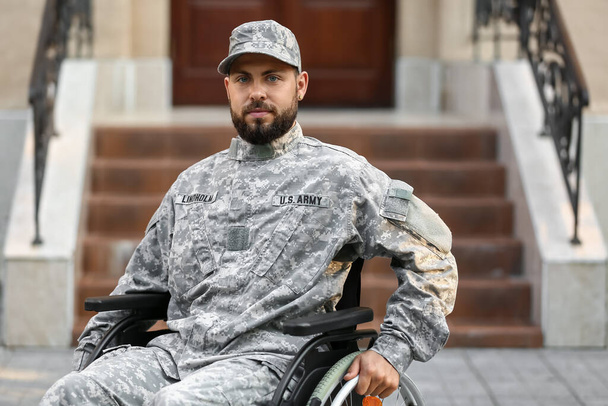 Young soldier in wheelchair on street - Φωτογραφία, εικόνα