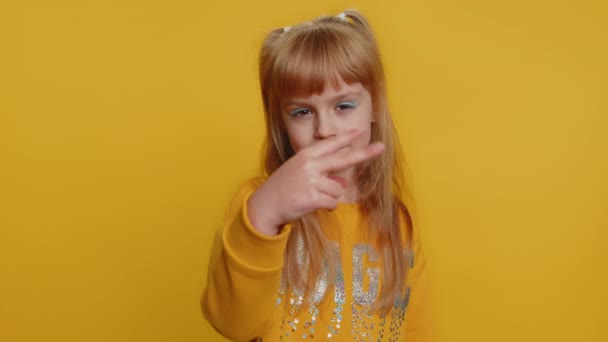 I am watching you. Young preteen child girl kid pointing at her eyes and camera, show I am watching you gesture, spying on someone, see. Female little toddler children isolated on yellow background - Footage, Video