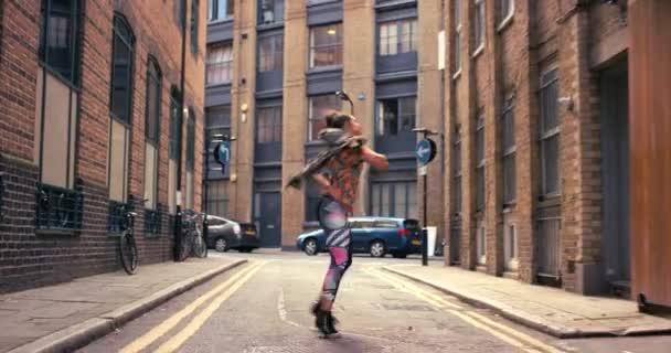 Woman, dancing and in the city for celebration, training for entertainment gig and happy outdoor. Young female, girl and artist dance, practice routine and dancer with freedom on street and creative - Footage, Video