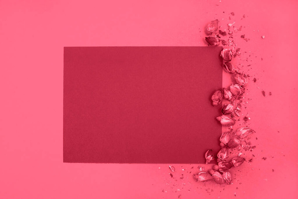 A blank sheet of paper and dried roses on a monochrome background. Top view, space for text. Color Viva Magenta. Demonstrating the colors of 2023. - Fotoğraf, Görsel