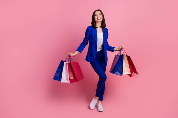 Photo of funny pretty positive lady wear stylish clothes outfit rejoice purchases empty space isolated on pink color background. - Фото, изображение