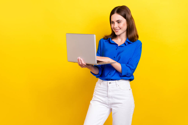 Photo of concentrated focused adorable ukrainian lady use netbook macbook stand empty space isolated on yellow color background. - Foto, imagen