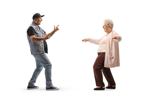 Full length profile shot of a mature man dancing with a senior lady isolated on white background - Fotoğraf, Görsel