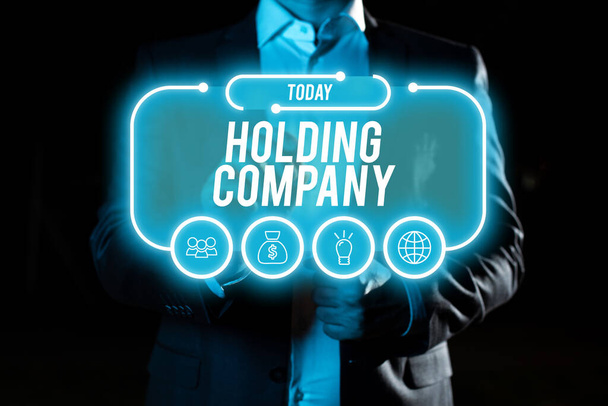 Teksti osoittaa inspiraatiota Holding Company, liikeidea varastot omaisuutta ja muuta rahoitusomaisuutta jonkun hallussa - Valokuva, kuva